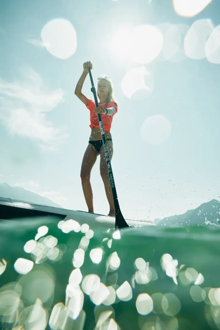 blonde women stand up paddling water view