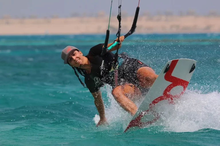 Kitesurfer lands after jump in blue water