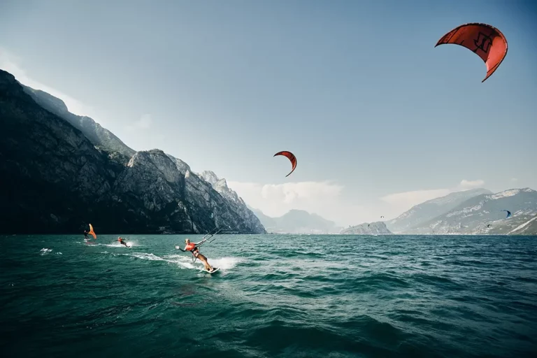kitesurfer with red kites on Lake Garda